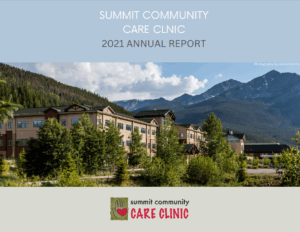 Summit Community Care Clinic 2021 Annual Report cover featuring the clinic's building surrounded by greenery and mountains in the background, emphasizing healthcare services in a scenic environment.