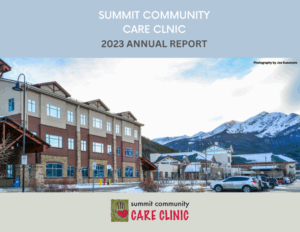 Exterior view of Summit Community Care Clinic, featuring a modern building surrounded by mountains, with a clear sky in the background, representing the 2023 Annual Report.